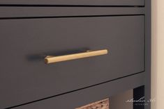 a close up of a drawer with a gold handle on the top and bottom drawers