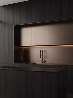 a modern kitchen with dark wood cabinets and stainless steel faucet, along with a black countertop