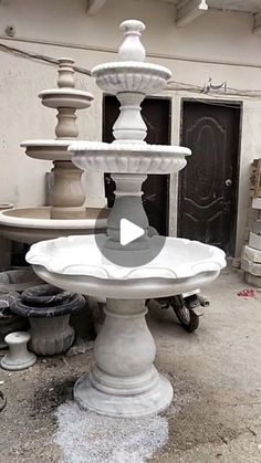 a large white fountain sitting in front of a building