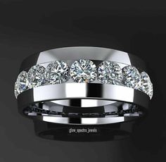 a white gold ring with five diamonds on the inside and outside, set against a black background