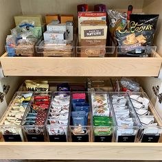 the shelves are filled with different types of snacks and food items in plastic bins