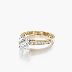 a yellow gold engagement ring with a single diamond in the center and side stones on each band