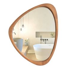 a bathroom with a sink, mirror and bathtub on the wall next to it