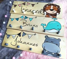 three wooden signs with animals on them