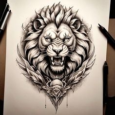 a drawing of a lion's head on paper with ink and pencils next to it