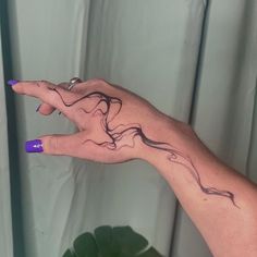 a woman's hand with a tattoo on it