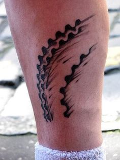 a close up of a person's foot with a tattoo on it