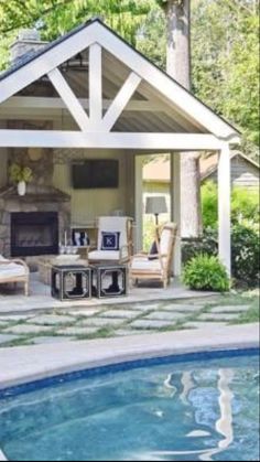 an outdoor living area with pool and fireplace