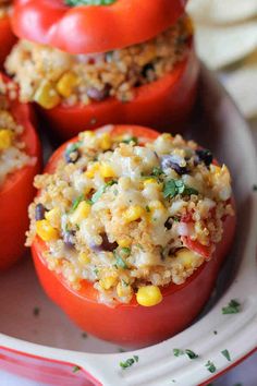 stuffed tomatoes with rice and vegetables on a plate