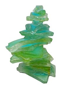 a stack of green glass pieces sitting on top of each other