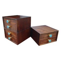 two wooden boxes sitting side by side on top of each other, one with blue knobs