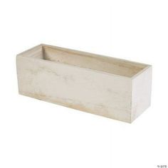 a white planter sitting on top of a table