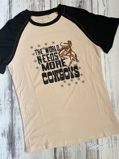 The World Needs More Cowboys Tee: Celebrate the spirit of the Wild West with our classic tee in vintage soft fabric. Let your inner cowboy shine with our timeless and comfortable tee. Super soft! True to size 95% Rayon/ 5% Spandex Size Fits XS 0 Small 2/4 Medium 6/8 Large 10/12 XL 14/16 2X 18/20 3X 22/24 The World Needs More Cowboys, Western Duster, Duster Dress, Western Handbags, Concealed Carry Purse, Western Graphic Tees, Crazy Train, Duster Jacket, The Wild West