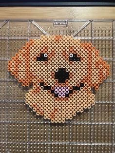 an orange dog is made out of perler beads