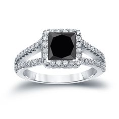 a black and white diamond ring with diamonds on it's sidestone, set in 18k white gold