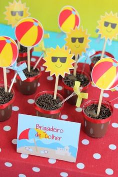 a table topped with potted plants covered in dirt and paper sunflower toppers