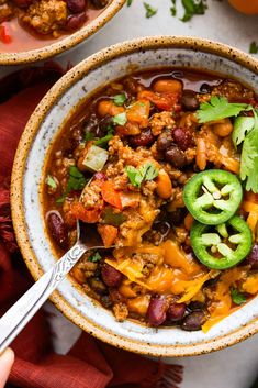 two bowls filled with chili and beans