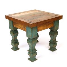 an old wooden table with green paint and wood trimmings on the legs, against a white background