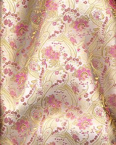 a pink and gold fabric with flowers on it