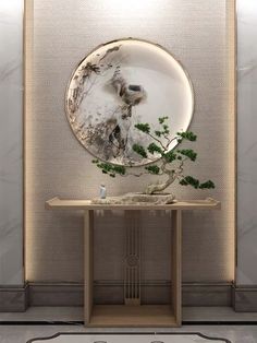 a round mirror sitting on top of a wooden table next to a vase filled with flowers