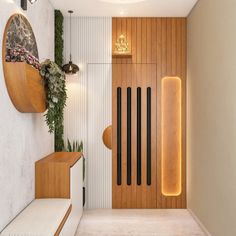 a modern entry way with wood paneling and plants on the wall, along with white walls