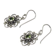 Peridot glows at the center of sterling silver blooms. Bali's Nyoman Rena crafts these stunning earrings by hand. Sterling silver & peridot Hook earrings Combination finish Handmade in & fairly traded from Indonesia Due to the handmade nature of this product, exact color and pattern of stone may vary. Green Sterling Silver Flower Earrings, Green Sterling Silver Flower-shaped Earrings, Handmade Green Sterling Silver Flower Earrings, Handmade Green Flower Earrings In Sterling Silver, Green Sterling Silver Flower Drop Earrings, Silver Peridot Drop Earrings, Silver Peridot Earrings For May Birthstone, Sterling Silver Flower Earrings, Paw Print Jewelry