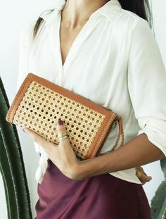 Doriane Rattan Clutch is made using leather and rattan to give a sophisticated and resort feel. Features a zip closure and a detachable handle, the bag holds items organized and neatly. Two Inside Zip Pocket Credit Card Holder Detachable Handle Measurement : Lgth ~ 31cm - 12.25 " Hght ~ 17 cm - 7 " Depth ~ 4.5cm - 1.75" Straps ~ detachable wrist handle Luxury Tan Bag With Removable Pouch, Rattan Clutch, Resort Vibes, Handmade Clutch, Bamboo Bag, Design Bag, Wicker Bags, Beading Techniques, Rattan Bag