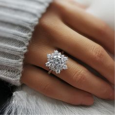 a woman's hand with a diamond ring on it