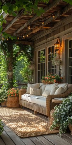 a porch with wicker furniture and potted plants