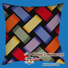 a multicolored plaid pillow with the words hooked creations com written in white on it