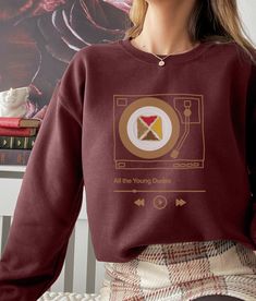 "Introducing The Marauders sweatshirt, a must-have addition to the wardrobe of any fan of the fanfic \"All The Young Dudes.\" This sweatshirt features a 70s retro vintage aesthetic design, showcasing the iconic group known as The Marauders. A sturdy and warm sweatshirt bound to keep you warm in the colder months. A pre-shrunk, classic fit sweater that's made with air-jet spun yarn for a soft feel and reduced pilling. * 50% cotton, 50% polyester * Pre-shrunk * Classic fit * 1x1 athletic rib knit collar with spandex * Air-jet spun yarn with a soft feel and reduced pilling * Double-needle stitched collar, shoulders, armholes, cuffs, and hem" Retro Fall Fan Merchandise Sweatshirt, Trendy Crew Neck Sweatshirt For Fan Merchandise, Fall Pop Culture Fan Merchandise Sweatshirt, Pop Culture Fan Merchandise Sweatshirt For Fall, Retro Crew Neck Sweatshirt For Fan Merchandise, Retro Graphic Print Sweatshirt For Fans, Vintage Aesthetic Design, Retro 70s Aesthetic, Retro Vintage Aesthetic