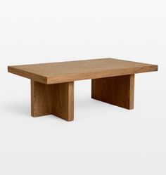 a wooden table sitting on top of a white floor