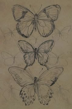 three butterflies sitting on top of each other in the middle of an old sheet of paper