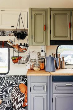 a kitchen with green cabinets and gray cupboards