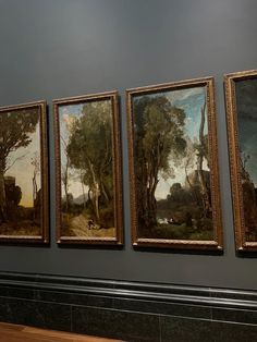 three paintings hanging on the wall next to each other