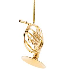 an ornament in the shape of a french horn hanging from a gold chain