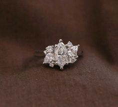 a diamond ring with three pear shaped diamonds