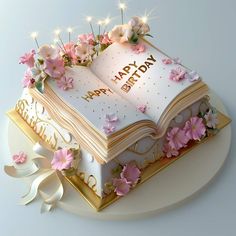 a birthday cake with an open book and flowers on it's side that says happy birthday