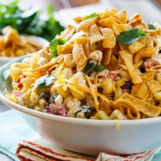 a bowl full of mexican food with tortilla chips