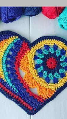 two crocheted hearts are next to each other