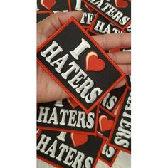 i love haters stickers are shown in the image, and there is also a hand holding one