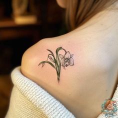 a woman with a tattoo on her shoulder