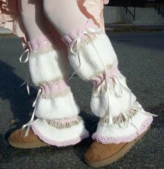 the legs of a woman wearing white and pink boots