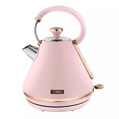 a pink tea kettle sitting on top of a white table next to a metal handle