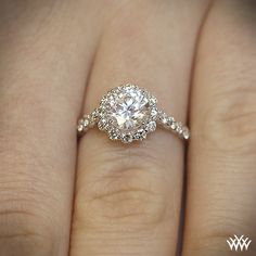 a woman's hand with a diamond ring on her finger and an engagement band