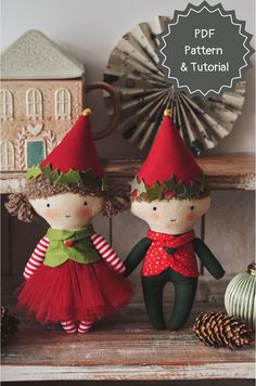 two handmade christmas dolls sitting on top of a table