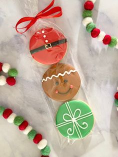 three decorated cookies sitting on top of a table