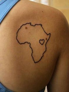 a woman with a tattoo on her shoulder showing the outline of africa in black ink