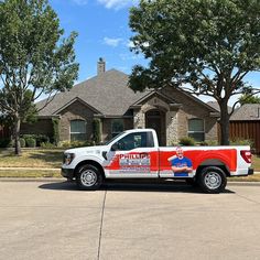 a red and white truck parked in front of a house