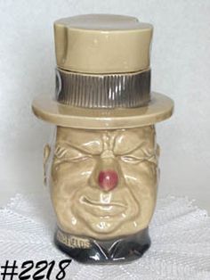 a ceramic face with a top hat on it